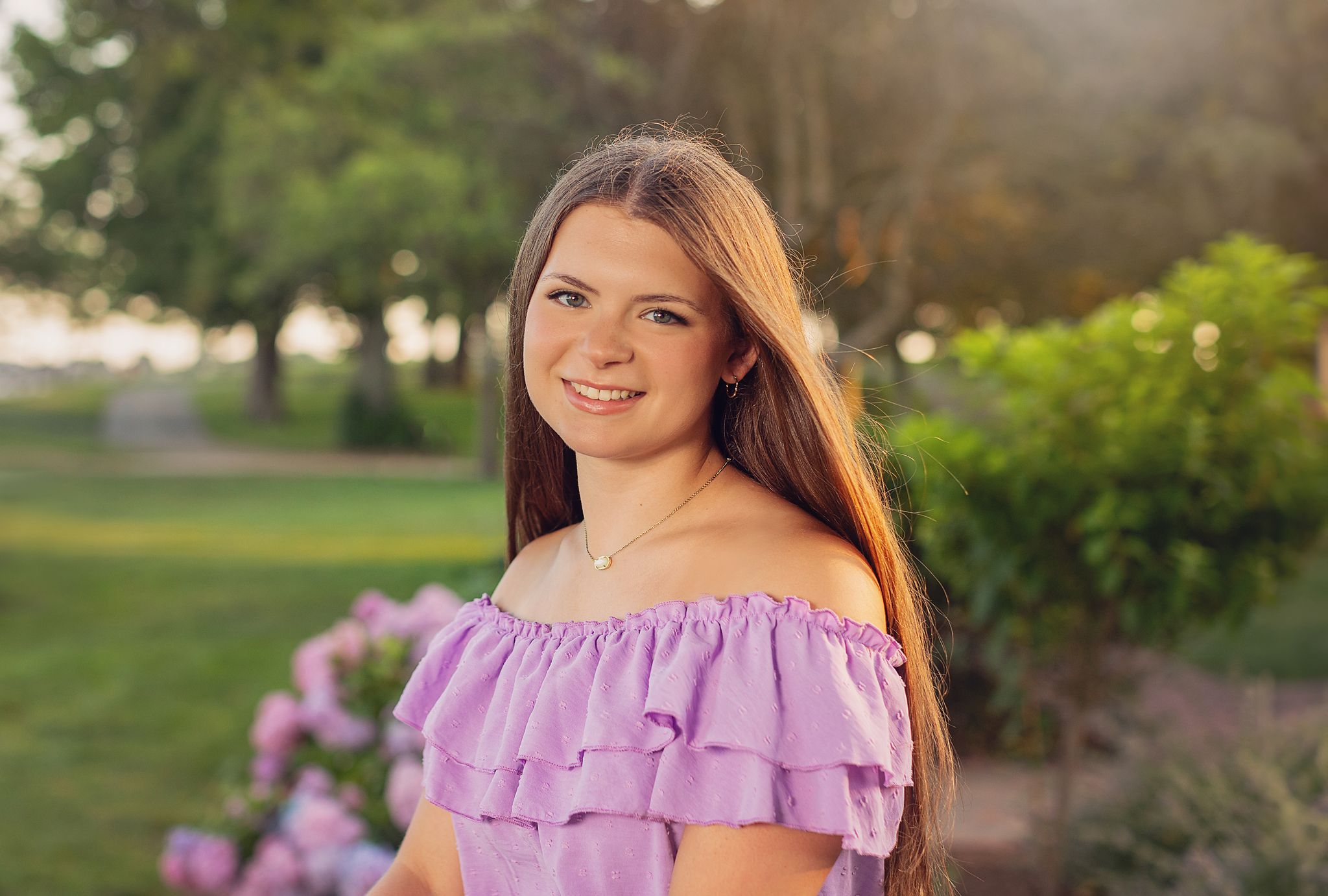 Senior girl in a field in purple top